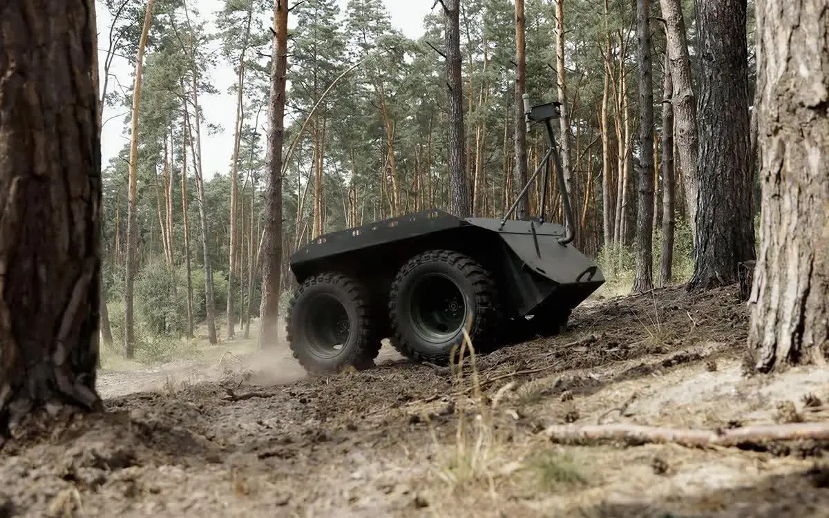 an-unmanned-ground-vehicle-moving-through-a-sparse-forest-landscape